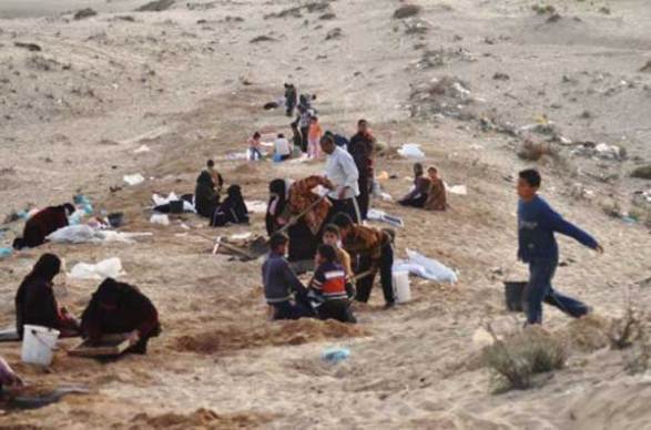 Yousef, 14, leads two of his younger brothers in their daily hunt for concrete materials off the highway between Khan Younis and Deir al-Balah.