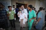 Girl is being evacuated by a doctor from Al-Acqasar hospital after being attacked by Israel Tanks