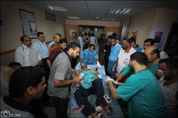 Patient being evacuated from Al-Qasar Hospital being shell by Israel tank shells